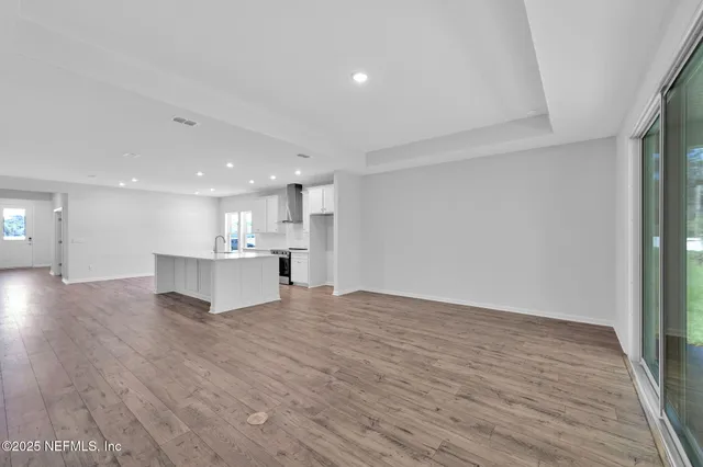 a view of kitchen with kitchen island and wooden floor