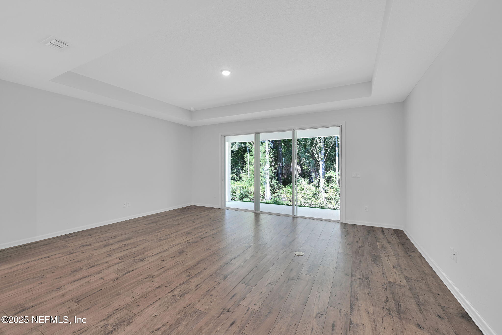97003 Mcgirts Creek Loop Yulee, FL 32097 - Photo 17 of 40 a view of an empty room with wooden floor and a window