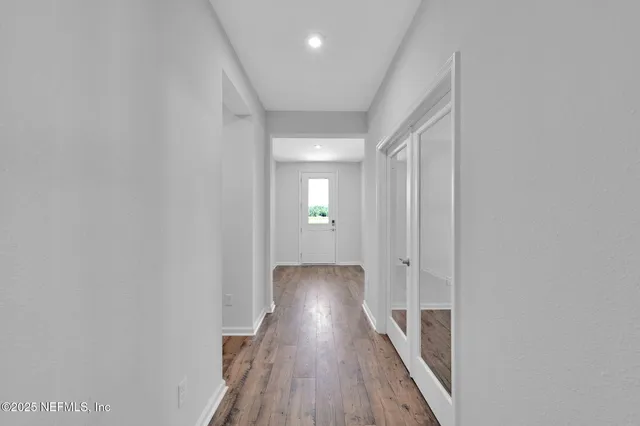 a view of hallway with wooden floor
