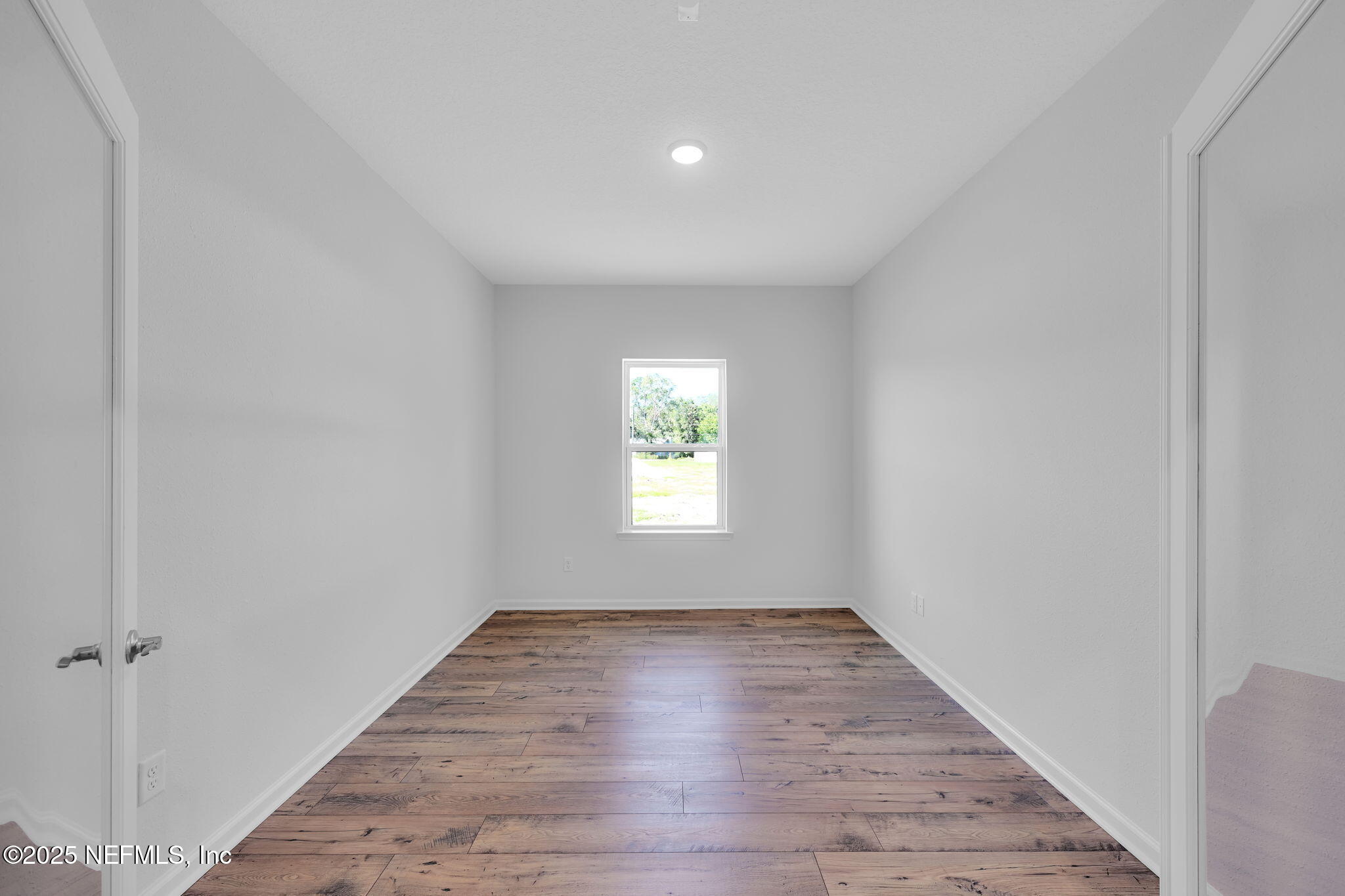 97003 Mcgirts Creek Loop Yulee, FL 32097 - Photo 6 of 40 a view of an empty room with wooden floor and a window