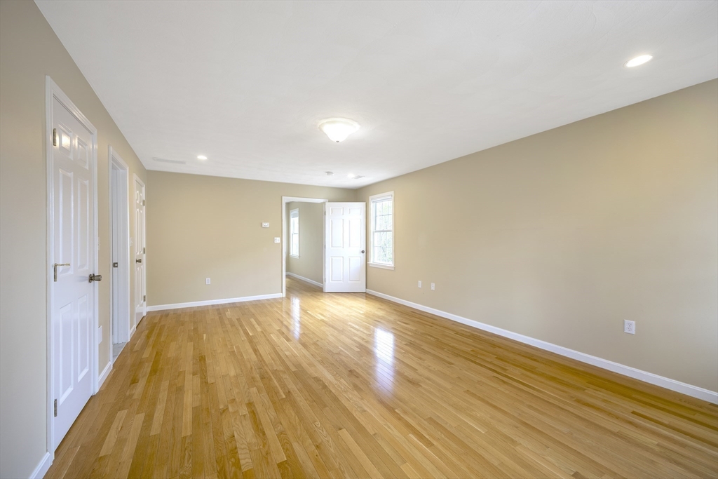 54 Spruce Street Winchester, MA 01890 - Photo 11 of 29 a view of an empty room with wooden floor and a window