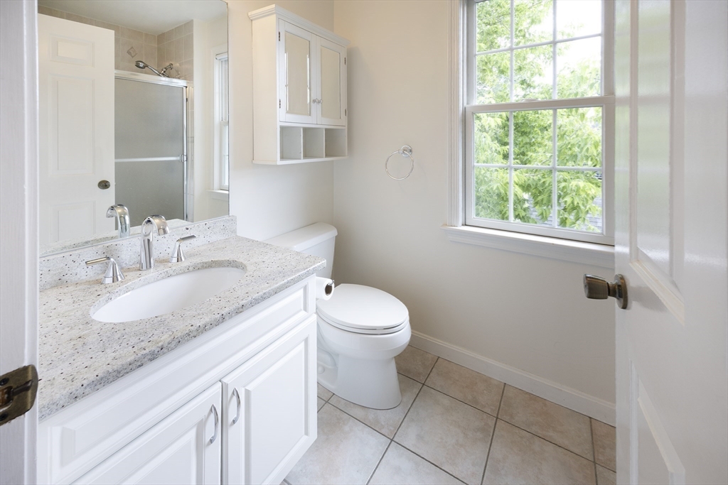 54 Spruce Street Winchester, MA 01890 - Photo 15 of 29 a bathroom with a granite countertop sink toilet and a mirror