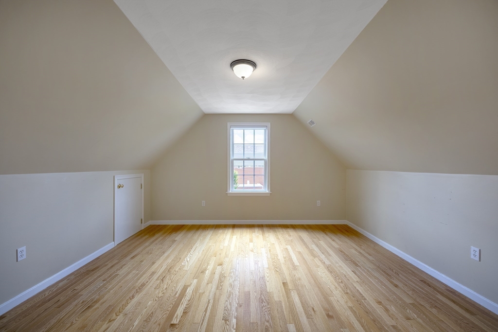 54 Spruce Street Winchester, MA 01890 - Photo 18 of 29 a view of empty room with wooden floor and fan