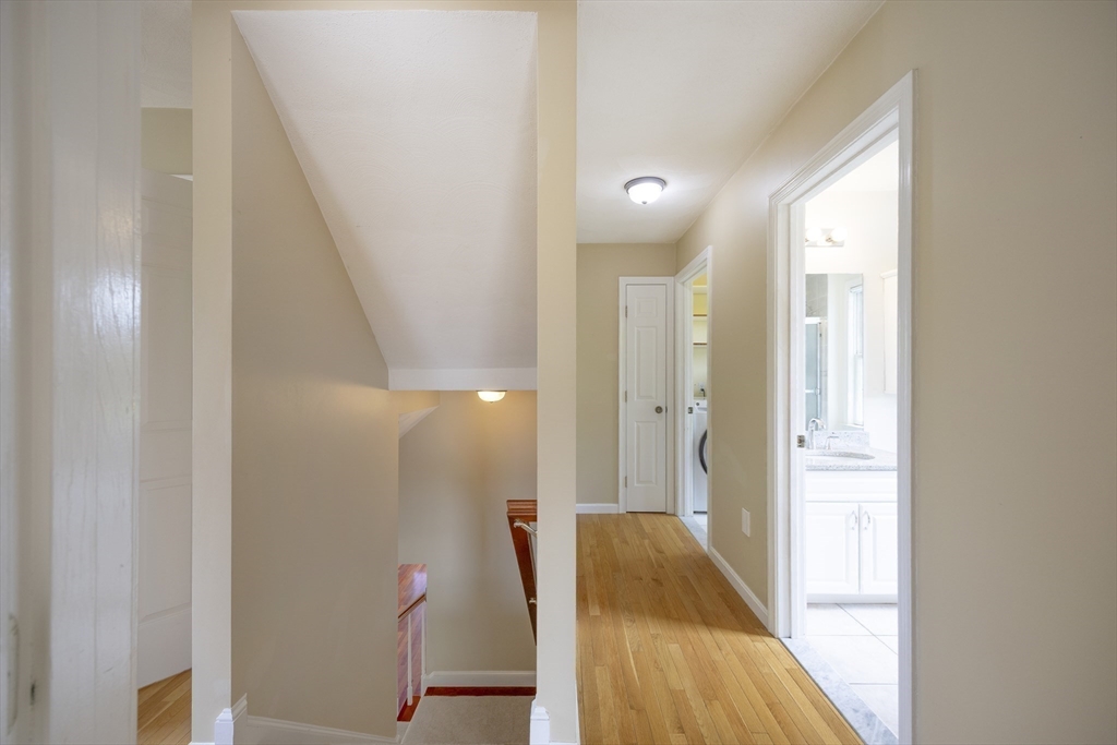 54 Spruce Street Winchester, MA 01890 - Photo 21 of 29 a view of a hallway with wooden floor and staircase