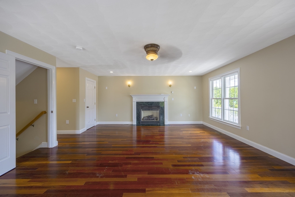 54 Spruce Street Winchester, MA 01890 - Photo 4 of 29 a view of a livingroom with wooden floor and a ceiling fan