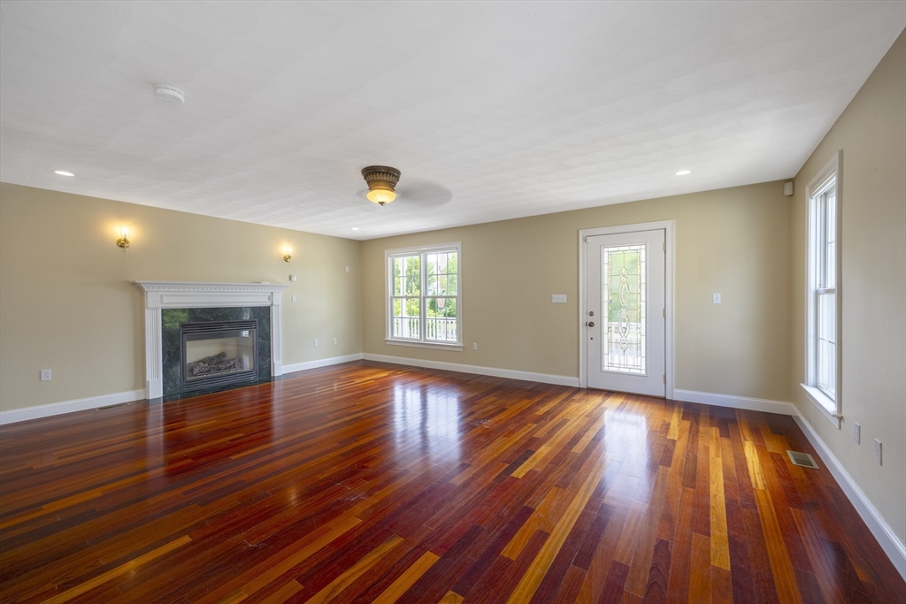 54 Spruce Street Winchester, MA 01890 - Photo 6 of 29 a view of an empty room with wooden floor and a window