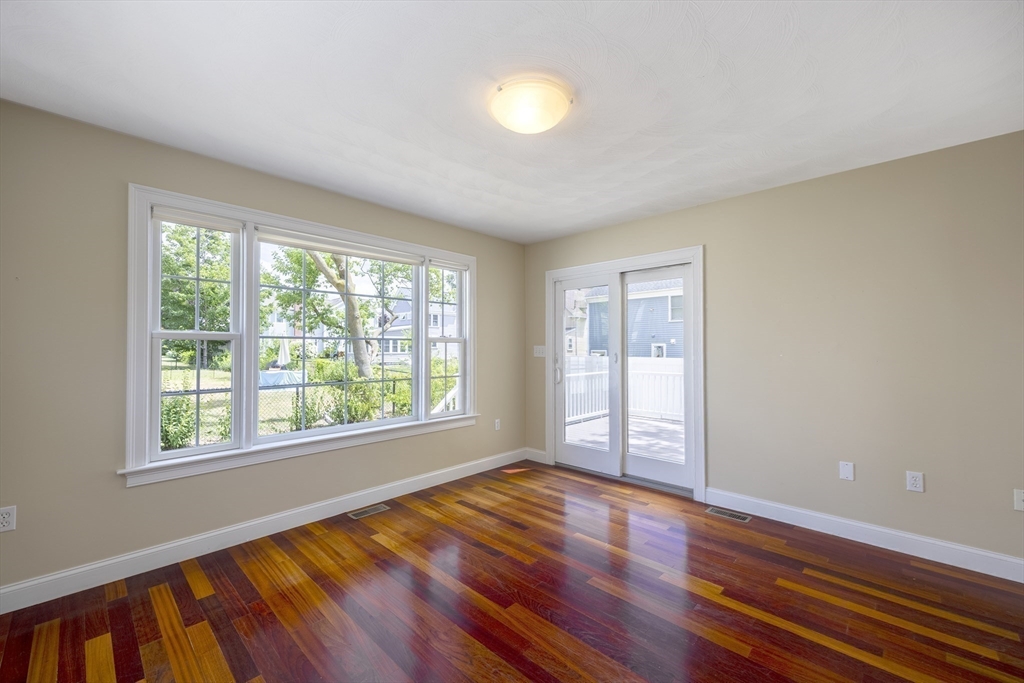 54 Spruce Street Winchester, MA 01890 - Photo 8 of 29 a view of an empty room with wooden floor and a window