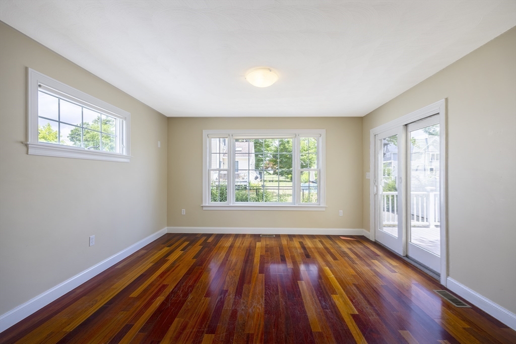 54 Spruce Street Winchester, MA 01890 - Photo 9 of 29 an empty room with wooden floor and windows