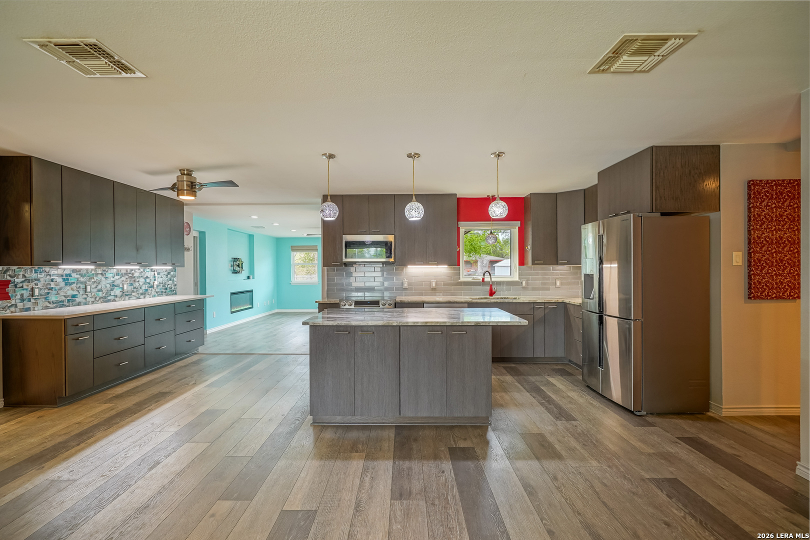 245 Windcrest Drive Windcrest, TX 78239 - Photo 11 of 50 a kitchen with stainless steel appliances a refrigerator and a wooden floors