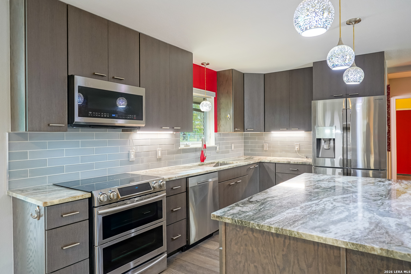 245 Windcrest Drive Windcrest, TX 78239 - Photo 12 of 50 a kitchen with stainless steel appliances granite countertop a sink a stove a microwave and wooden cabinets
