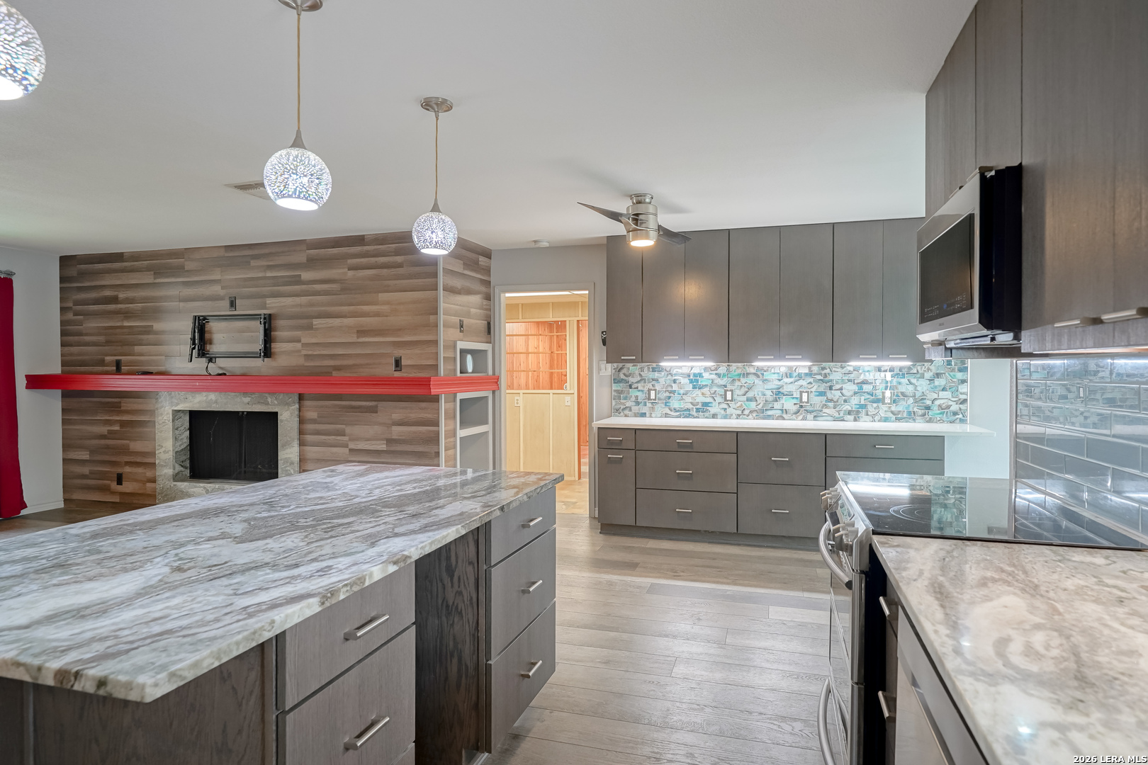 245 Windcrest Drive Windcrest, TX 78239 - Photo 13 of 50 a kitchen with stainless steel appliances granite countertop a sink a oven a stove and a wooden floors