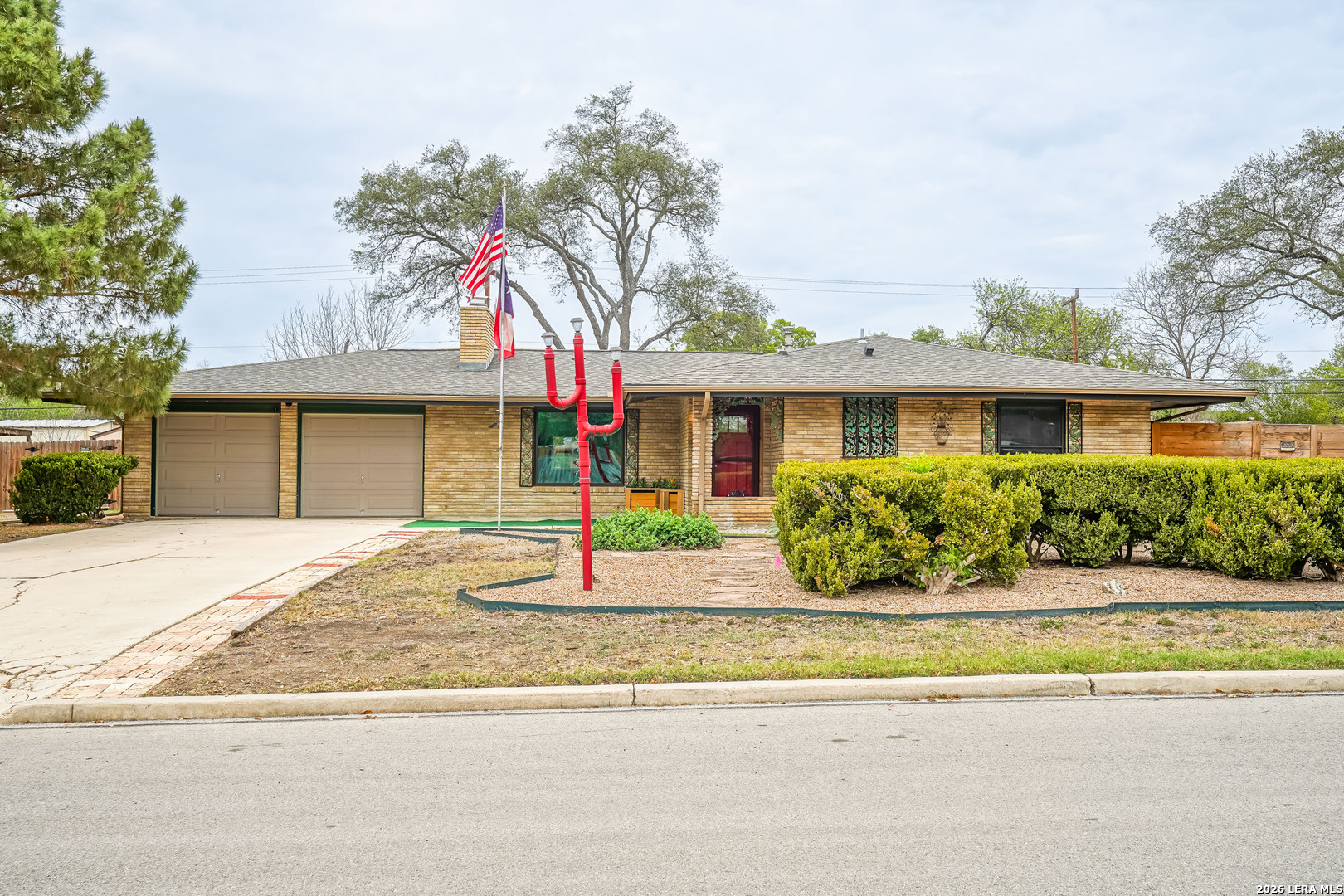 245 Windcrest Drive Windcrest, TX 78239 - Photo 2 of 50 a front view of a house with a garden and plants