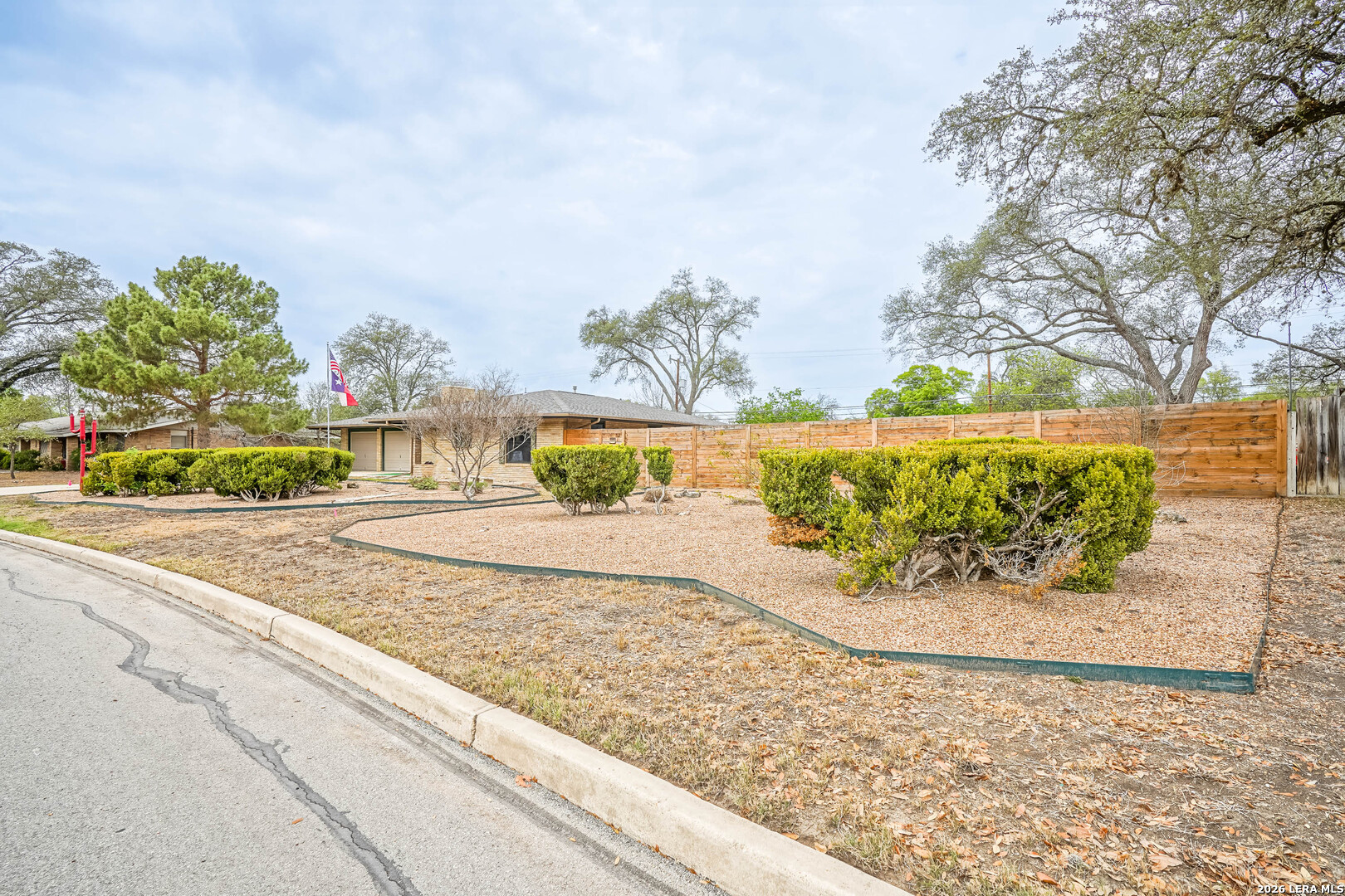 245 Windcrest Drive Windcrest, TX 78239 - Photo 3 of 50 a view of a garden with a bench