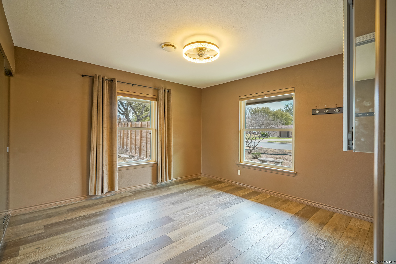 245 Windcrest Drive Windcrest, TX 78239 - Photo 36 of 50 an empty room with wooden floor and windows