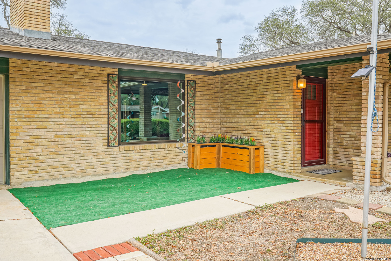 245 Windcrest Drive Windcrest, TX 78239 - Photo 5 of 50 a front view of a house with a yard and garage