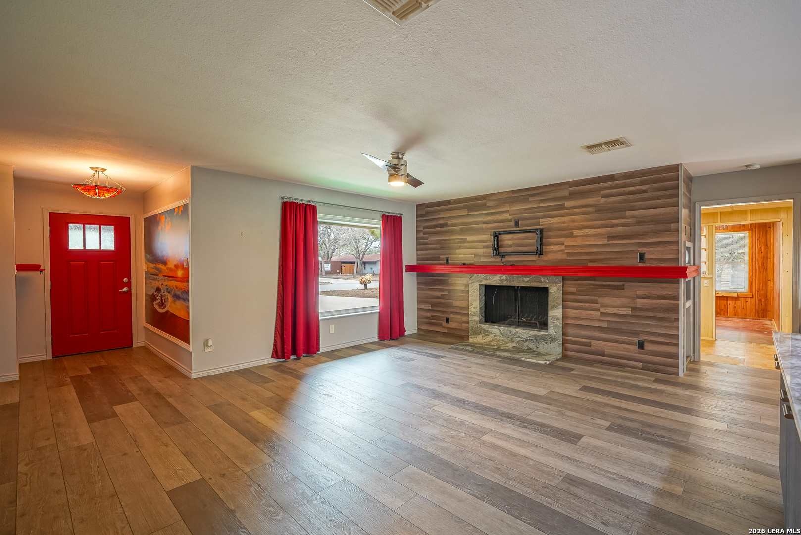 245 Windcrest Drive Windcrest, TX 78239 - Photo 8 of 50 a view of a livingroom with wooden floor and a fireplace