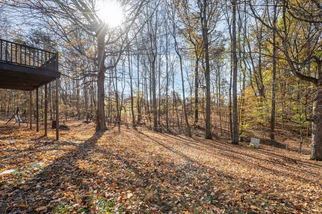 a view of large house with a yard covered in snow