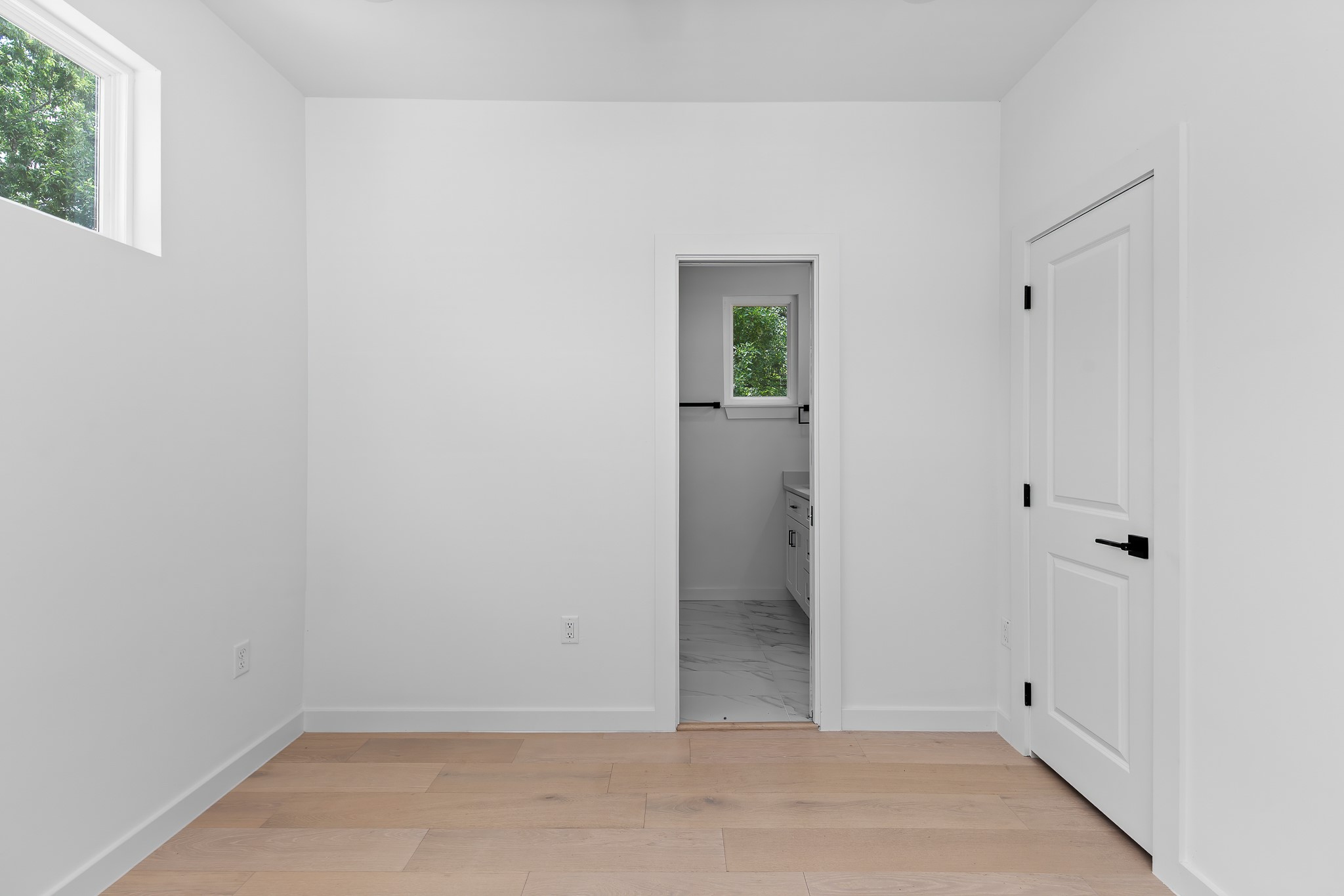 5305 Ledesma Road, Unit 4 Austin, TX 78721 - Photo 28 of 40 Blonde hardwood flooring complements the bright walls in this versatile interior space.