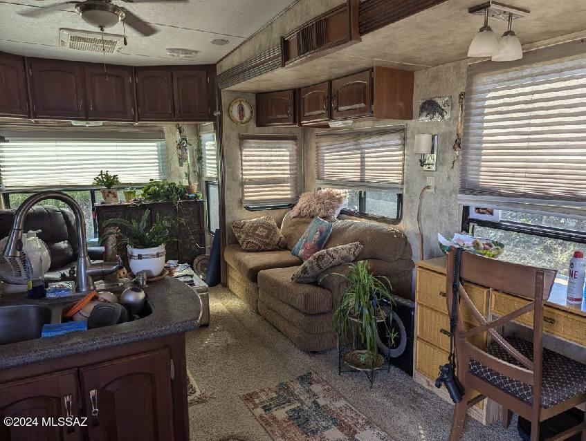 35700 South Cedar Creek Road Arivaca, AZ 85601 - Photo 42 of 44 a living room with furniture a window and potted plants