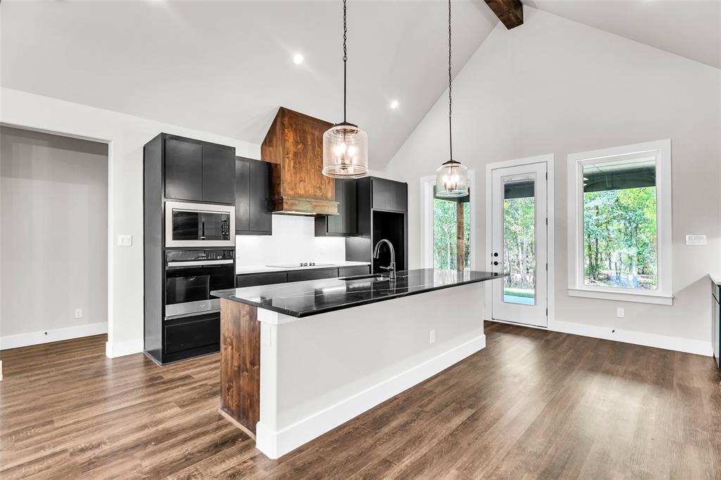 Lot 5 Slate Rock Road Ennis, TX 75119 - Photo 11 of 22 a kitchen with stainless steel appliances granite countertop a refrigerator a sink dishwasher a stove and a wooden floor
