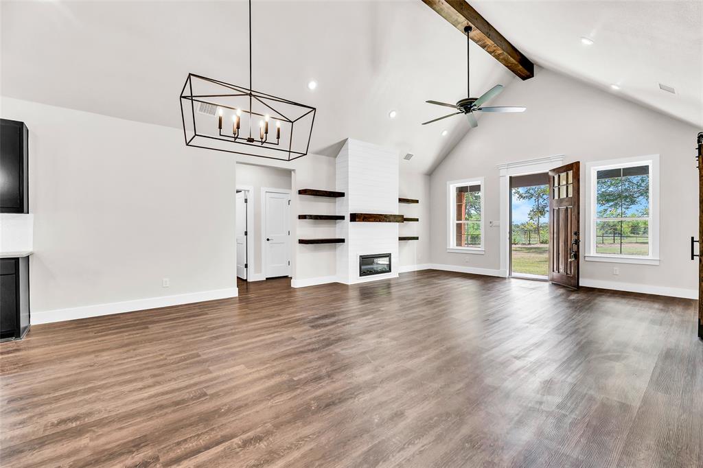 Lot 5 Slate Rock Road Ennis, TX 75119 - Photo 15 of 22 a view of an empty room with a window and wooden floor