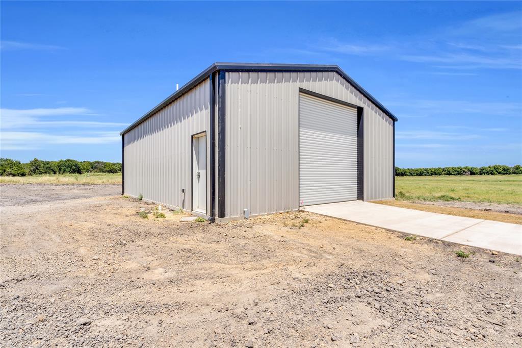 Lot 5 Slate Rock Road Ennis, TX 75119 - Photo 22 of 22 a view of an house with backyard and road
