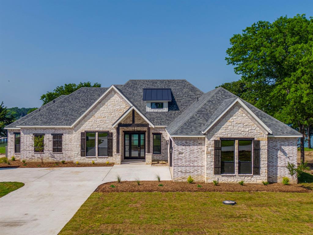 Lot 5 Slate Rock Road Ennis, TX 75119 - Photo 7 of 22 a front view of a house with a garden and trees
