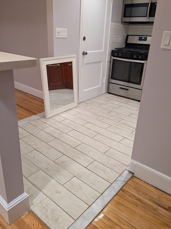 33 Paragon Road, Unit 1 Boston, MA 02132 - Photo 14 of 18 a bedroom with a bed and a stove