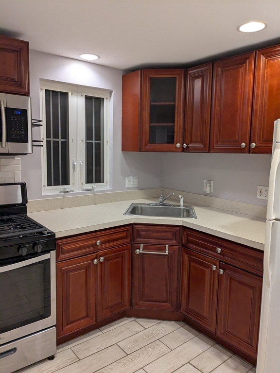 33 Paragon Road, Unit 1 Boston, MA 02132 - Photo 15 of 18 a kitchen with a sink and a stove top oven