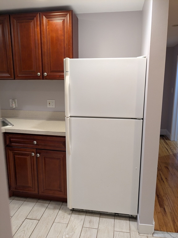 33 Paragon Road, Unit 1 Boston, MA 02132 - Photo 17 of 18 a white refrigerator freezer sitting in a kitchen