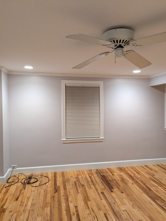 33 Paragon Road, Unit 1 Boston, MA 02132 - Photo 3 of 18 an empty room with a bed and wooden floor