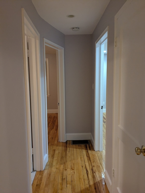 33 Paragon Road, Unit 1 Boston, MA 02132 - Photo 6 of 18 a view of a bedroom with wooden floor and closet