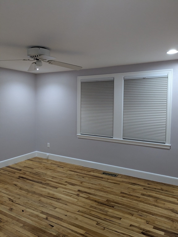 33 Paragon Road, Unit 1 Boston, MA 02132 - Photo 7 of 18 a view of an empty room with wooden floor