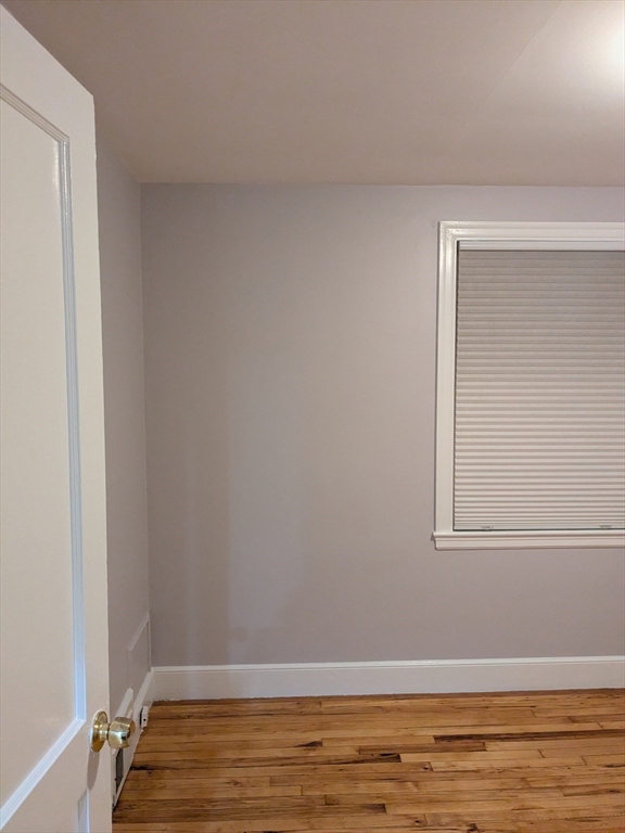 33 Paragon Road, Unit 1 Boston, MA 02132 - Photo 10 of 18 a view of a small space with wooden floor and a window