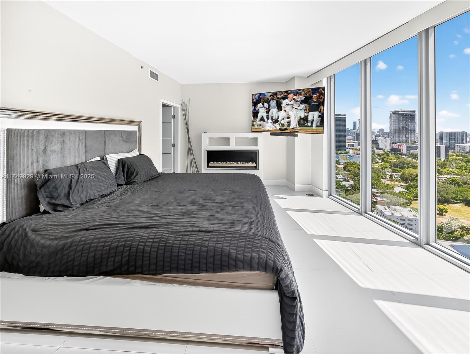 601 Northeast 36th Street, Unit 2201 Miami, FL 33137 - Photo 14 of 42 a bedroom with a large bed and a large window