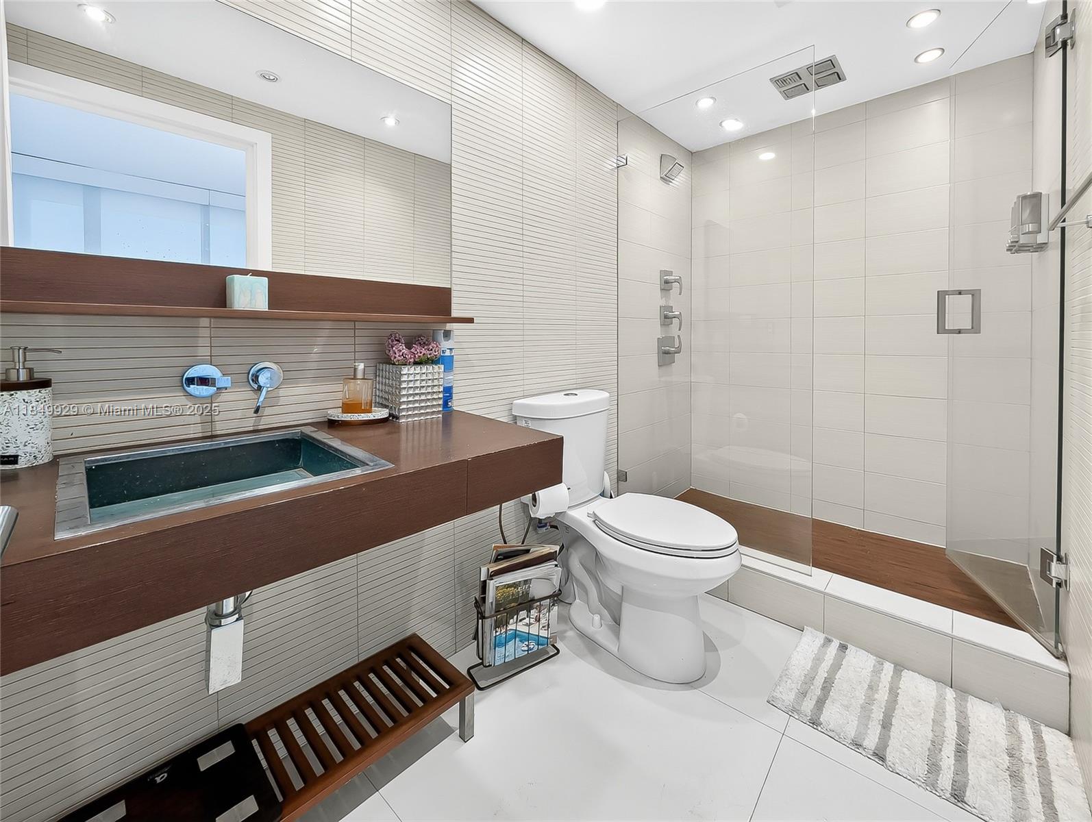 601 Northeast 36th Street, Unit 2201 Miami, FL 33137 - Photo 19 of 42 a bathroom with a toilet a sink and shower