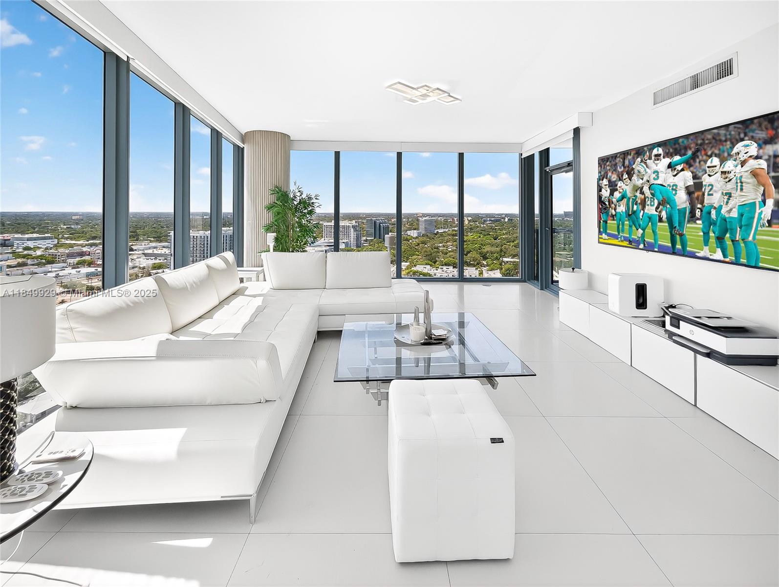 601 Northeast 36th Street, Unit 2201 Miami, FL 33137 - Photo 2 of 42 a living room with furniture large windows and flat screen tv