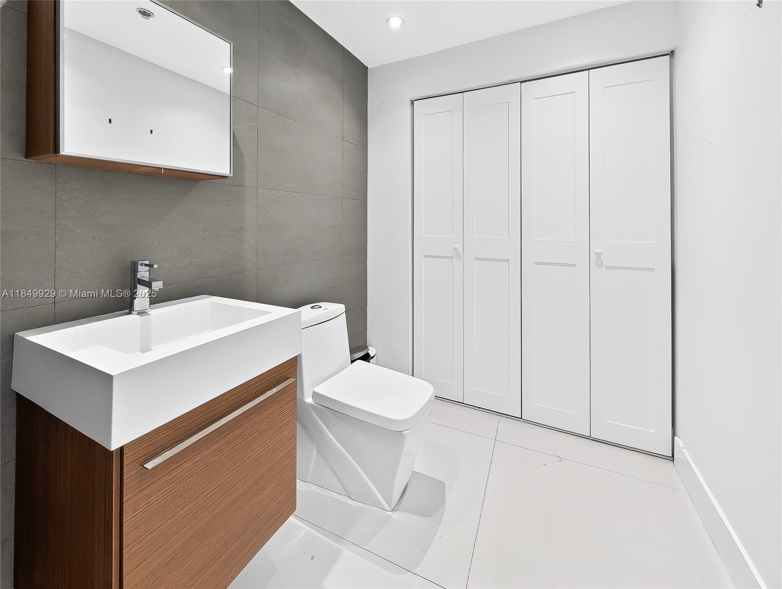 601 Northeast 36th Street, Unit 2201 Miami, FL 33137 - Photo 21 of 42 a bathroom with a sink toilet and vanity