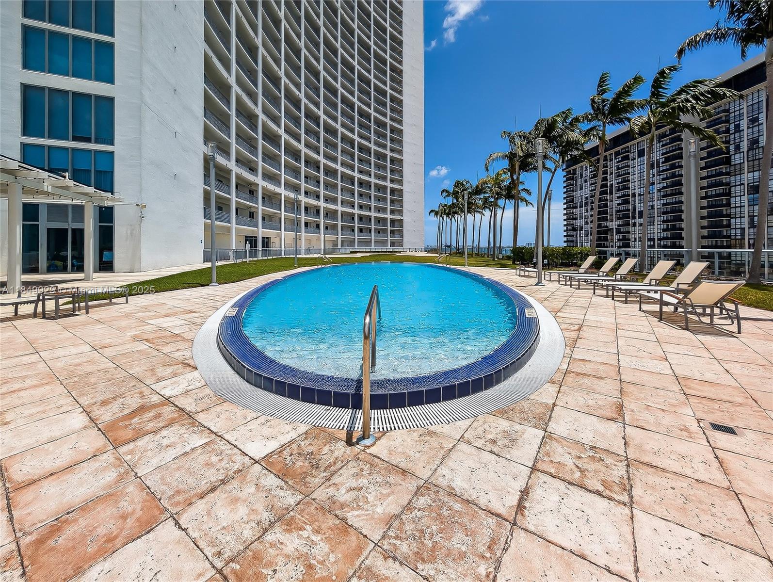 601 Northeast 36th Street, Unit 2201 Miami, FL 33137 - Photo 24 of 42 a view of a swimming pool with a lounge chairs