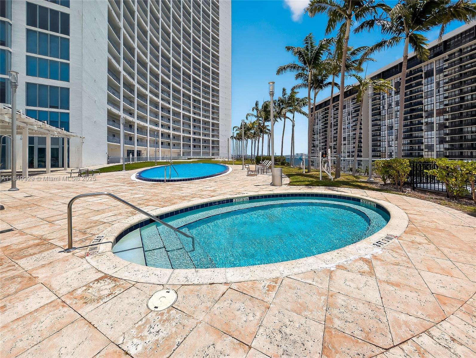 601 Northeast 36th Street, Unit 2201 Miami, FL 33137 - Photo 25 of 42 a view of a swimming pool with a lounge chairs