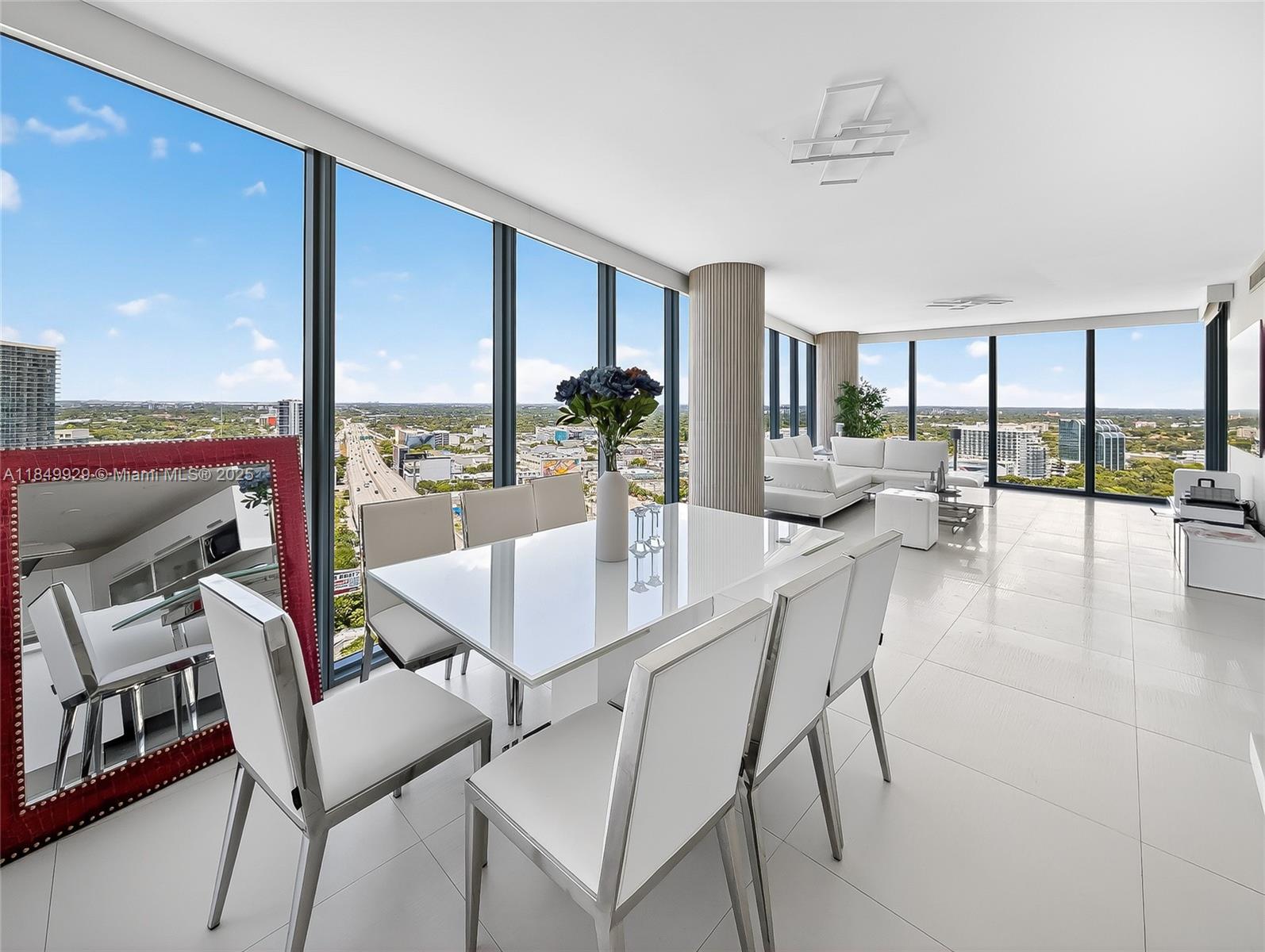 601 Northeast 36th Street, Unit 2201 Miami, FL 33137 - Photo 7 of 42 a dining room with furniture and a floor to ceiling window