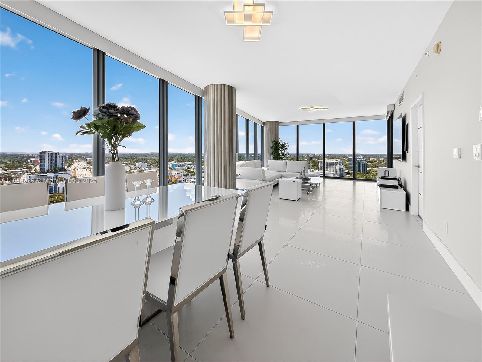 601 Northeast 36th Street, Unit 2201 Miami, FL 33137 - Photo 9 of 42 a dining room with furniture and chandelier