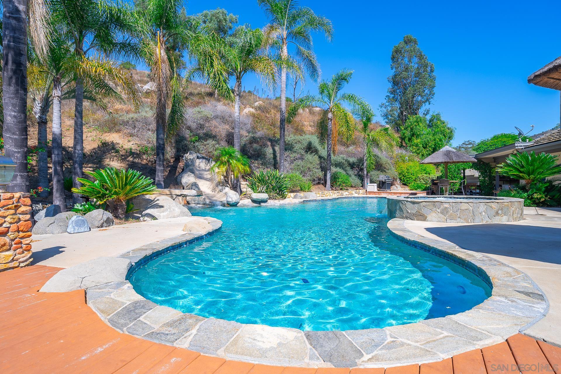 14574 Millas Road Poway, CA 92064 - Photo 67 of 75 a view of a swimming pool with a yard