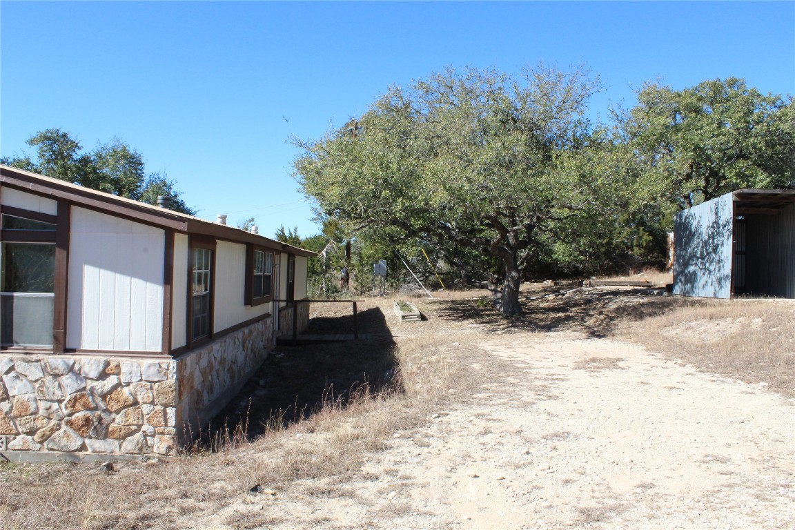 14111 South Green Hills Loop, Unit B Austin, TX 78737 - Photo 13 of 13 a view of a back yard of the house