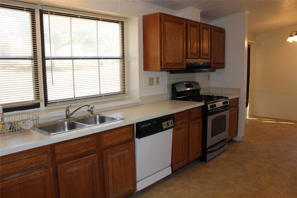 14111 South Green Hills Loop, Unit B Austin, TX 78737 - Photo 3 of 13 a kitchen with stainless steel appliances granite countertop a sink stove and cabinets