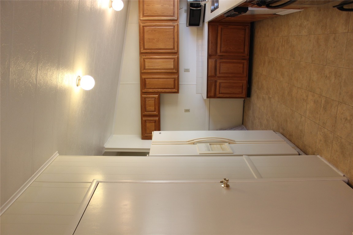 14111 South Green Hills Loop, Unit B Austin, TX 78737 - Photo 5 of 13 a kitchen with a refrigerator and a counter top