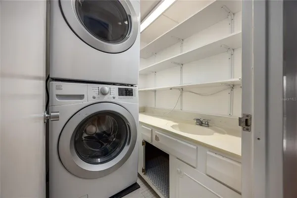 a spacious bathroom with a shower sink and mirror