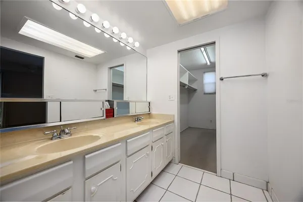 an empty room with a window and a ceiling fan
