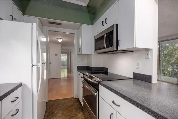 a kitchen with granite countertop a sink and cabinets