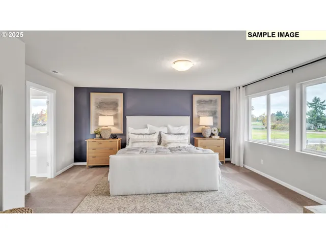 a living room with a white couches and large couches next to a window